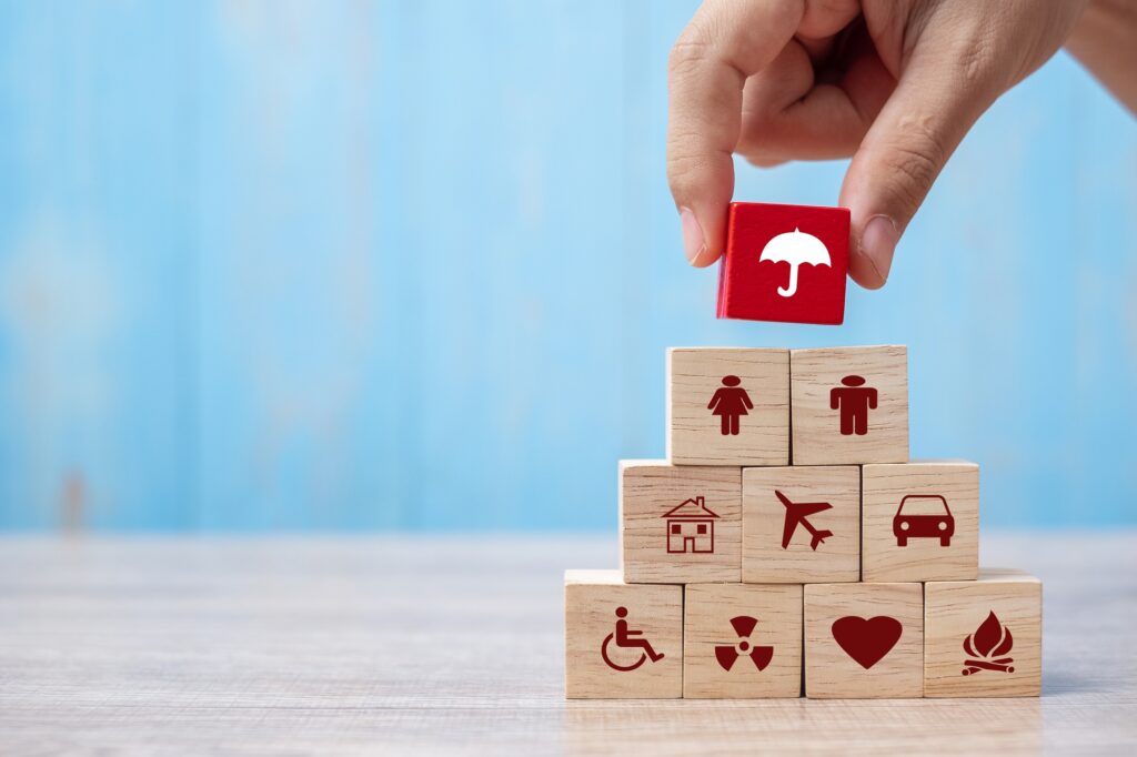 Insurance and risk management symbols arranged as a protection pyramid